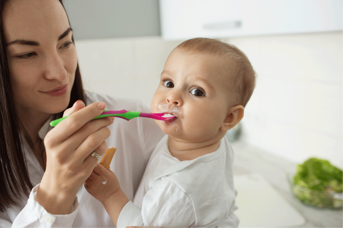 mother-feed-cute-baby-with-spoon.png